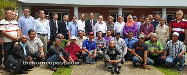 Uggah (standing front, seventh right) with representatives of fishermen associations from across Sarawak in a group photo after the meeting at the IAC in Kuching.