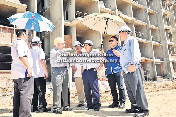 BERJALAN LANCAR: Kurup (tiga kanan) meninjau tapak pembinaan projek perumahan PR1MA Borneo Cove diiringi oleh Zolkopli, Hamsan, Ruji dan Nasir.