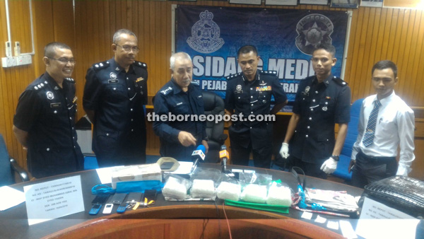 Rashid showing the 5,120.66 grams of syabu and other items seized.