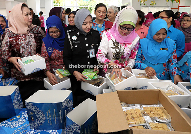 FROM THE HEART: Minister of Welfare, Women and Community Wellbeing Datuk Fatimah Abdullah (second from right), Assistant Minister for Early Child Education and Family Development Sharifah Hasidah Sayeed Aman Ghazali (left) and others putting food into small boxes. A total of 6,500 packets of foods are being prepared for government enforcement and security agency personnel who will be working during Hari Raya Aidilfitri. 