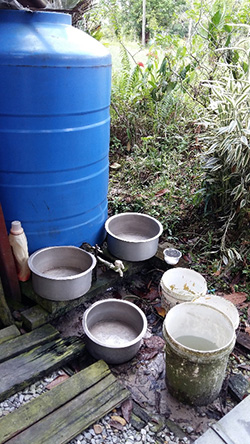 This is where Maree takes his bath everyday — a small area with a water tank and some water containers.