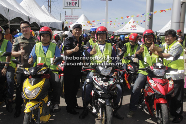 UTAMAKAN KESELAMATAN: Herdiansah (kanan), Parum (tiga kiri) dan Roland (kiri) menunjukkan tanda bagus ketika menyempurnakan pelancaran kempen keselamatan jalan raya.