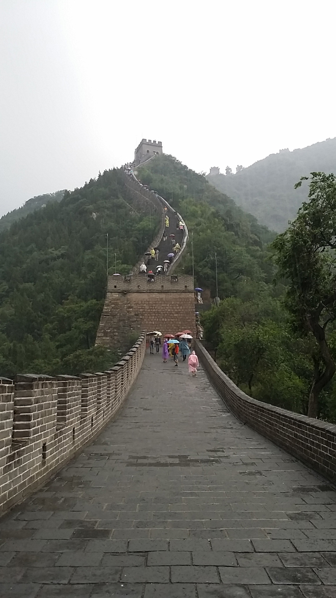 Climbers are seen carrying umbrellas at the beginning stretch of the Juyongguan Great Wall.