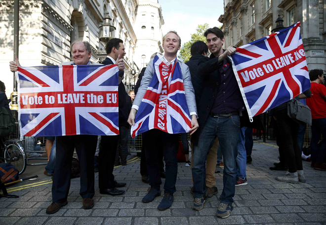 ‘Vote leave’ supporters waving Union flags following the result of the EU referendum outside Downing Street in London yesterday. — Reuters photo