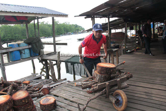 A villager sends firewood to the smokehouse.