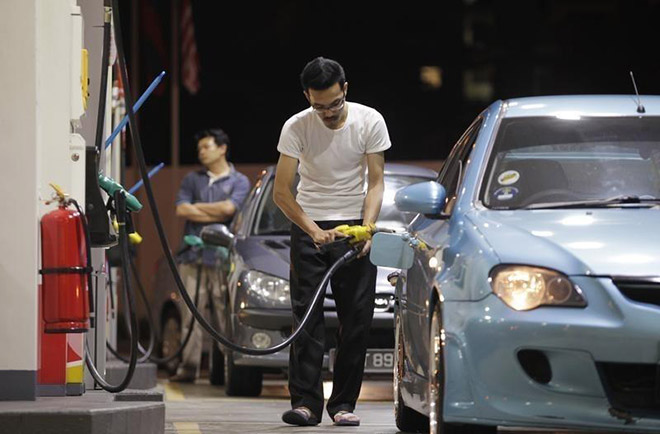 A motorist pumps petrol at a petrol station in Kuala Lumpur. Zakaria says the government’s initiative in increasing the blend for the transport sector from B7 to B10 and introducing B7 for the industrial sector was a timely move as the biodiesel programme will help stabilise the price of CPO. — Reuters photo