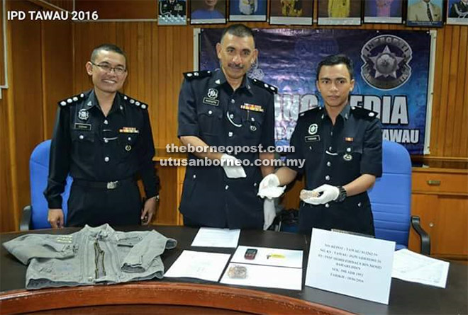 Mustaffa showing the seized drugs and other items during the press conference.