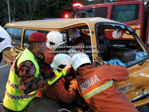 Fire and rescue personnel trying to free the woman who was pinned at the driver’s seat.