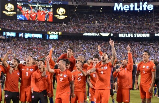 Chile's players celebrate after defeating Argentina in the penalty shoot-out and winning the Copa America Centenario final, in East Rutherford, New Jersey, on June 26, 2016. Photo by AFP