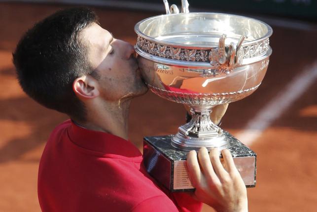 Novak Djokovic celebrates with his trophy. Photo by Reuters