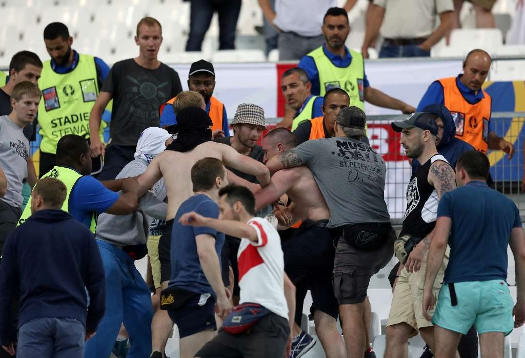 Groups of supporters fight at the end of the Euro 2016 match between England and Russia at the Stade Velodrome in Marseille on June 11, 2016. Photo by AFP