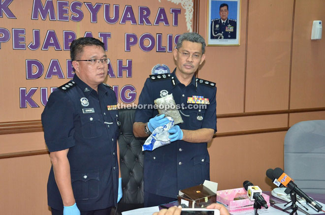 Abang Ahmad (right) together with Kuching Narcotics Crime Investigation Department head ASP Chundang Sangau showing the drugs which were seized during the raid.