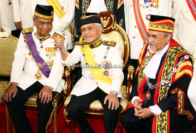 The Head of State in a light moment with Chief Minister Datuk Patinggi Tan Sri Adenan Satem (left) and State Legislative Assembly (DUN) speaker Datuk Amar Mohd Asfia Awang Nassar (right) after their official group photo was taken at the lobby of the DUN Complex yesterday. — Photo by Muhammad Rais Sanusi