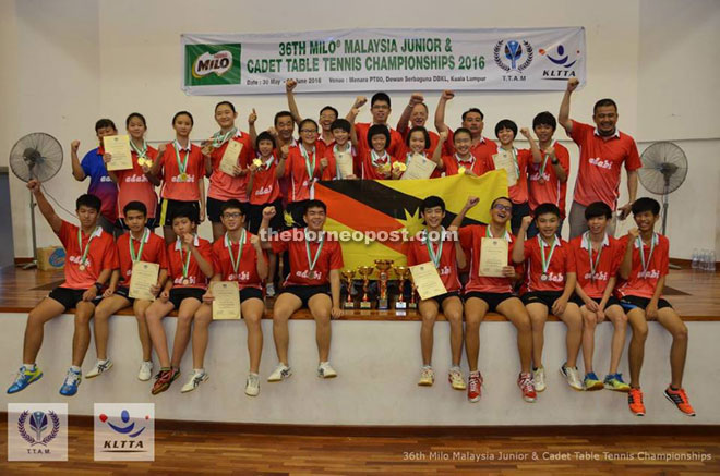 Ling (right) and TTAS chairman Tan Keng Yau (fourth right) celebrating with the Sarawak contingent after emerging as the overall champions again in the 36th Milo Malaysia Junior and Cadet Table Tennis Championship in Kuala Lumpur recently. — Photos courtesy of Kuala Lumpur Table Tennis Association