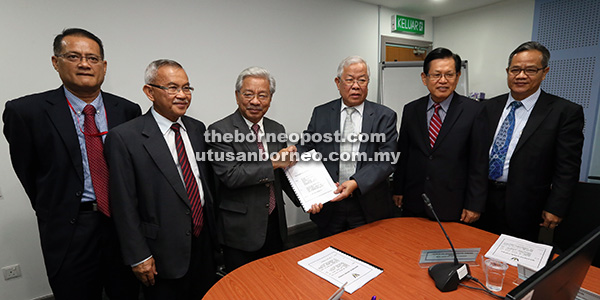 Manyin (third right) hands over duties to Masing as others look on. — Photo by Kong Jun Liong