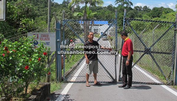 Donny (left) and Lau waiting with BAT 6 outside Bayai Water Treatment Plant to see if there is anyone from the plant who can explain the reasons for the dry taps in Sri Aman.