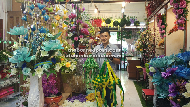 Jong introduces some of the artificial flowers and decorative accessories like ketupat available at Katai. 