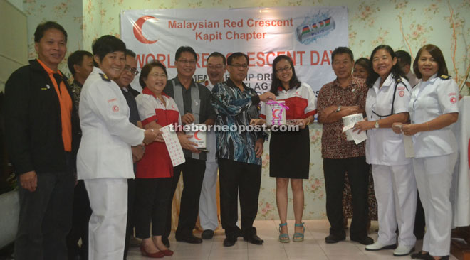 Jamit (front, fifth right), Mabong District Officer Douglas Pungga (front, sixth right) and Kapit Resident Joseph Belayong (front, third right) launch the sale of MRC stickers.