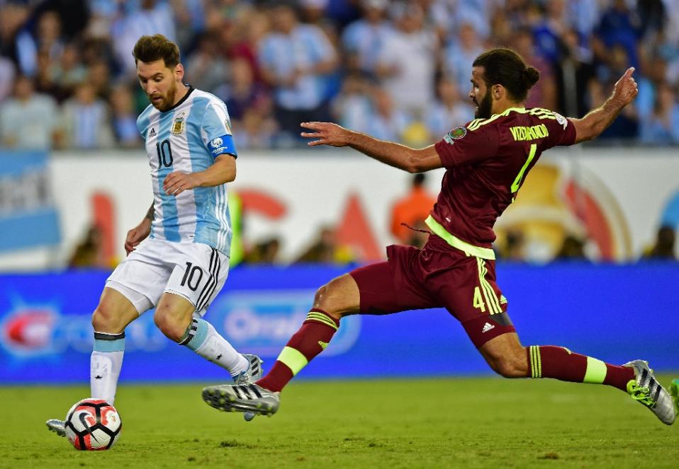 Argentina's Lionel Messi (L) fights for the ball with Venezuela's Oswaldo Vizcarrondo during their Copa America Centenario quarter-final match, in Foxborough, Massachusetts, on June 18, 2016. Photo by AFP