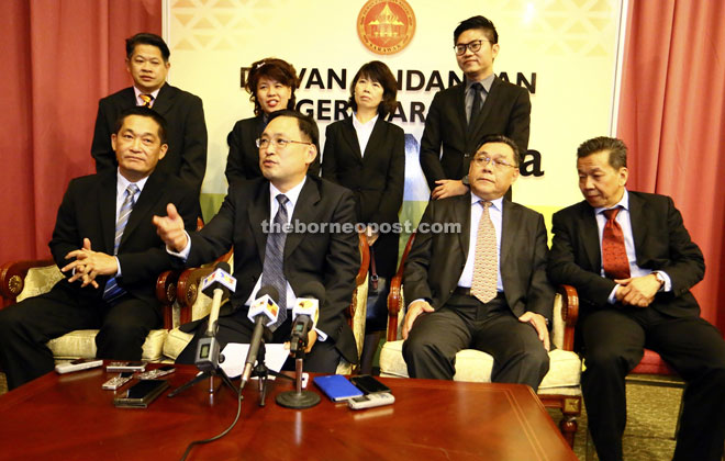 Chong (seated second left) speaking during the press conference alongside See (seated left), Yong (standing second left), Wong (standing right) and other DAP elected representatives. — Photo by Kong Jun Liung