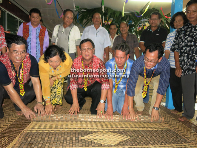 Rolland (on the floor, centre), Rengayan (on Rolland’s right) and Sylvester (on Roland’s far left), taking part in the symbolic ‘Ngiling Bidai’ ceremony to mark the closing of Gawai Dayak celebrations.  