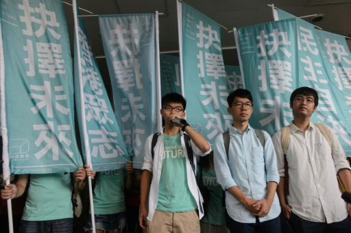 Student leaders (L to R) Joshua Wong, Nathan Law and Alex Chow speak to the media before facing a court verdict over charges related to a protest leading up to pro-democracy rallies in 2014. - AFP Photo