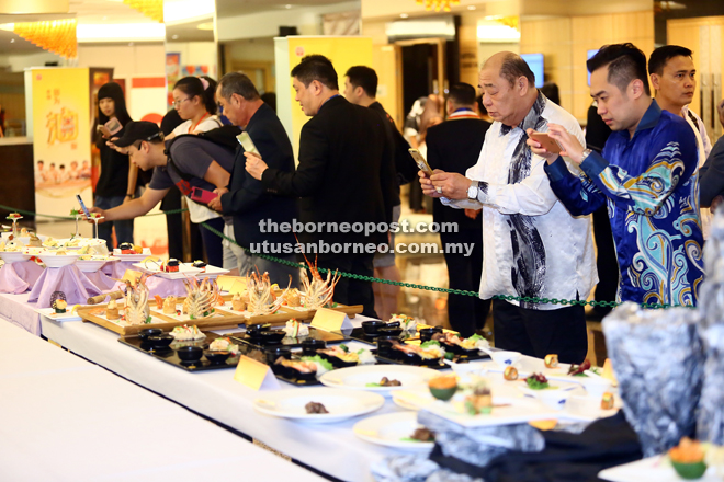 Visitors photograph the various fantastic food displays.