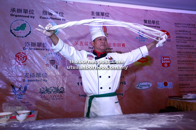 A chef displays his noodle-making skills at the exhibition area.