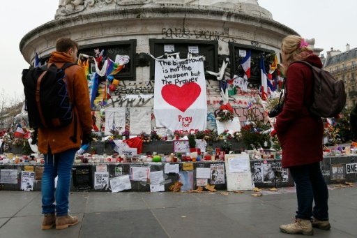 People gather in front of a makeshift memorial in Place de la Republique square in Paris on December 13, 2015 -AFP photo