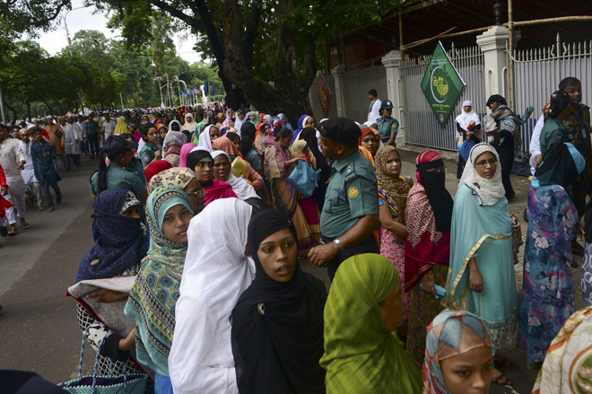 Bangladeshi Muslims wait in a queue for a security check prior to Eid al-Fitr prayers in Dhaka. Suspected Islamists carried out a new deadly attack at a huge prayer gathering in northern Bangladesh to celebrate the end of Ramadan, only days after the mass murder of hostages in the capital Dhaka. — AFP photo