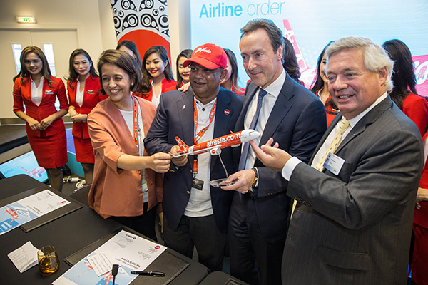 Fernandes (second left) and AirAsia Bhd chief executive officer Aireen Omar (left) signed the firm order of 100 A321neo aircraft for AirAsia yesterday with Airbus’s  Brégier (third left) and Airbus chief operating officer for customers, John Leahy (fourth left).