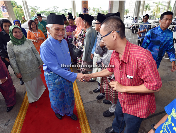 Taib (centre), with Nancy on his right, shakes hands with a guest upon his arrival at the old DUN Complex. — Photos by Tan Song Wei 