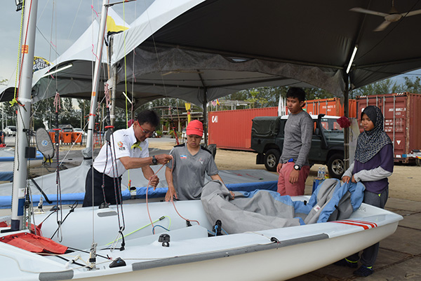 The Sabah Sukma sailing team checks on their boat. 