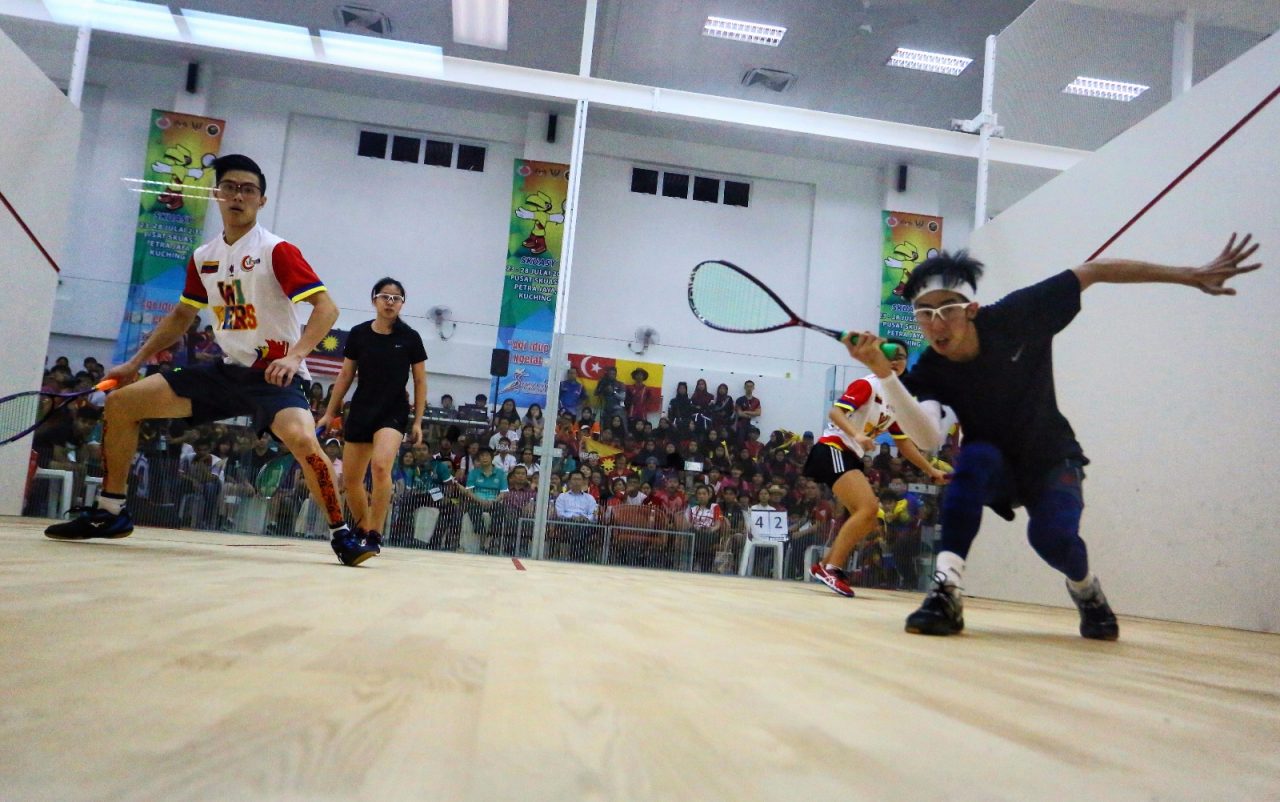 Sarawak pair Tay (right) and Ma (second left) giving it all during mixed double squash final today (July 22). Photo by Muhammad Rais Sanusi.