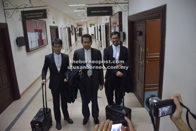 (From left) Poh, Taufik and Haresh outside the court room. 
