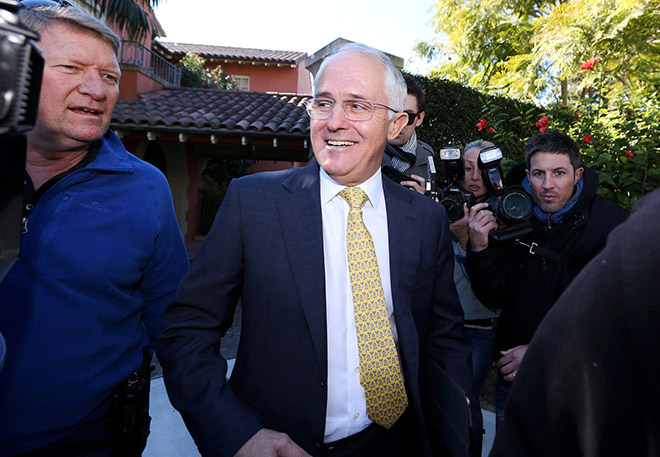 Turnbull smiles as he is surrounded by members of the media departing his home located in the Sydney suburb of Point Piper, Australia. — Reuters photo