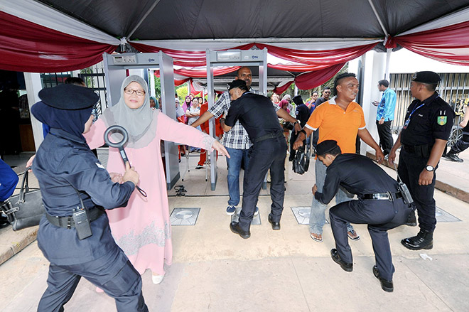 Visitors at the open house undergoing security check. — Bernama photo