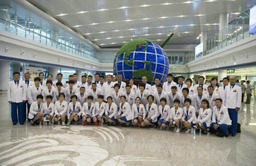 Members of North Korea's delegation for the 2016 Rio de Janeiro Olympic Games, pictured on July 26, 2016, pose for a group photo before leaving Pyongyang International Airport for Brazil