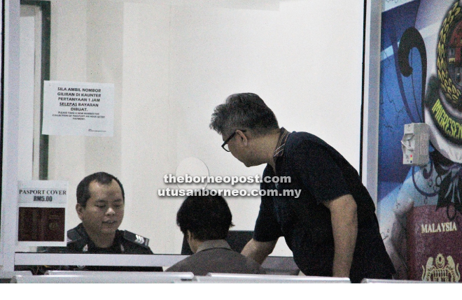 Applicants getting their passports processed at the Immigration Department counter in UTC Kuching.