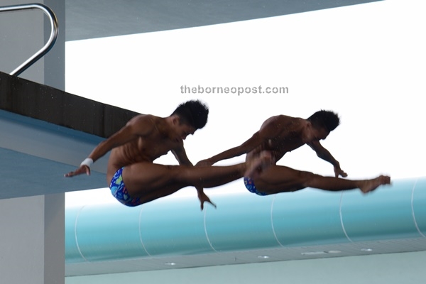 Slyvester Peter Gaing and Carlysle Chan Wee Chiek competing in the diving event.