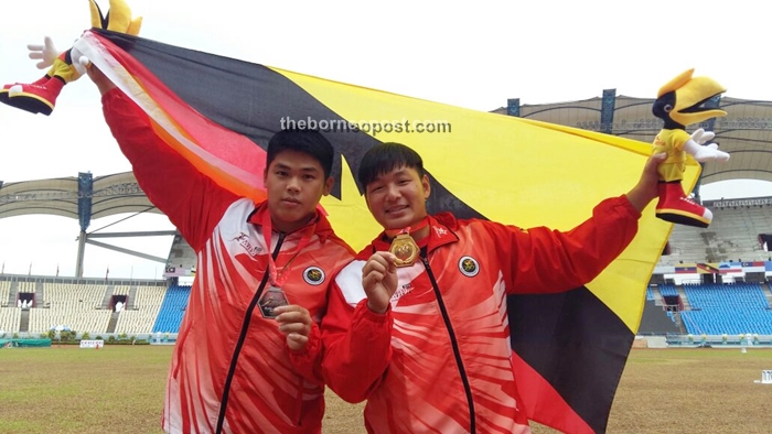 Wong (right) celebrates winning gold after the event.