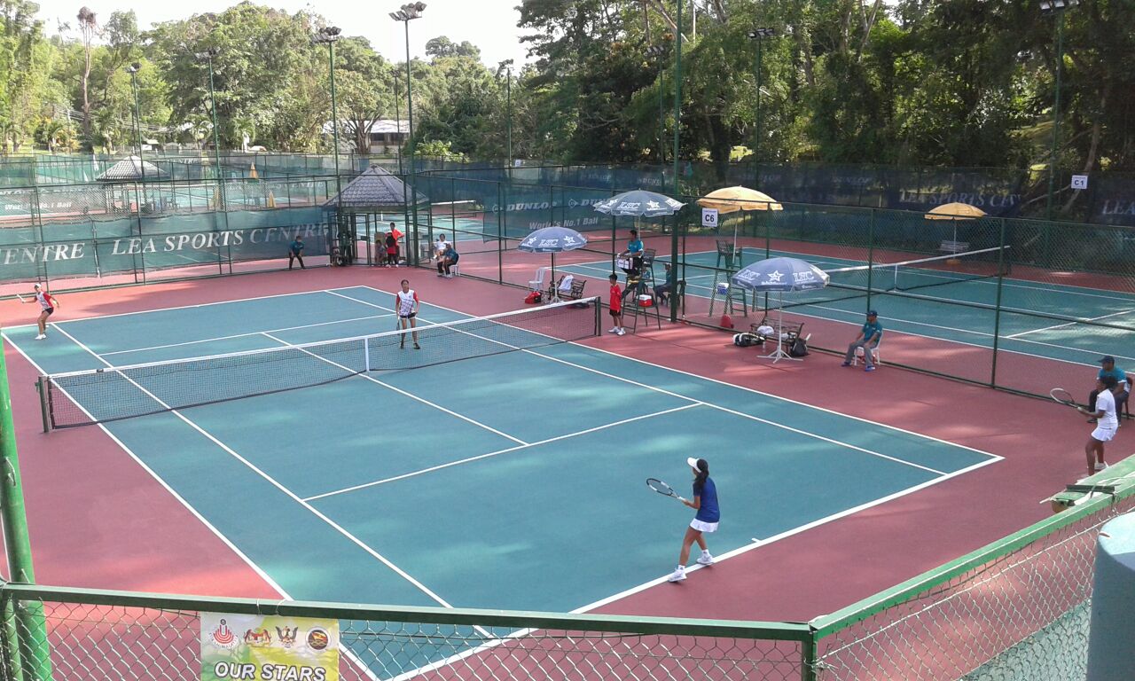 Sarawak team (in red) giving their all during the women's doubles semi-finals today.