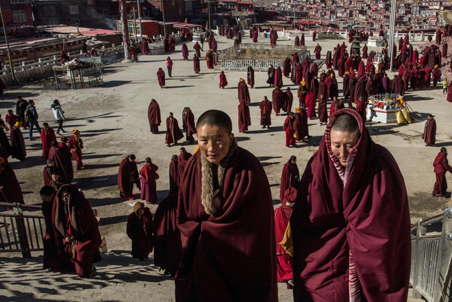 File photo shows Buddhist nuns leaving the monastery after praying at the Larung Gar Buddhist Institute in Sertar county (known as Seda in Chinese) in the remote Garze Tibetan Autonomous Prefecture in southwest China’s Sichuan province. — AFP photo