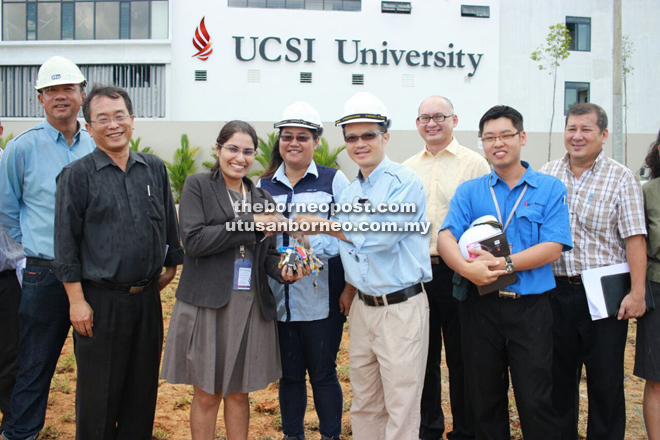USCI Sarawak COO Mukvinder (third left) receiving the keys to their new premises from Ir. Micheal Kiew (fourth right) during the recent official handover as Chang Jih Ren (second left) and others look on.