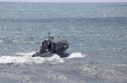 This photo taken on August 14, 2015 shows a patrol boat taking part in the search for wreckage from the missing MH370 plane off the coast of Saint-Marie on the French island of La Reunion -AFP photo