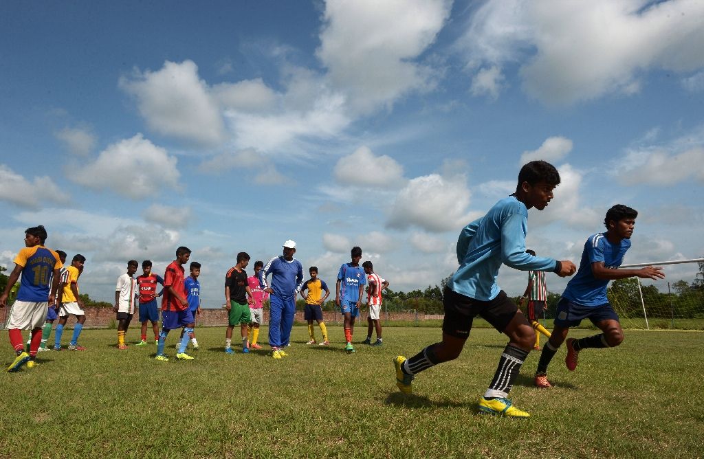 Under-privileged Indian schoolboys practice their football skills at The Durbar Sports Academy in Ramnagar. Photo by AFP