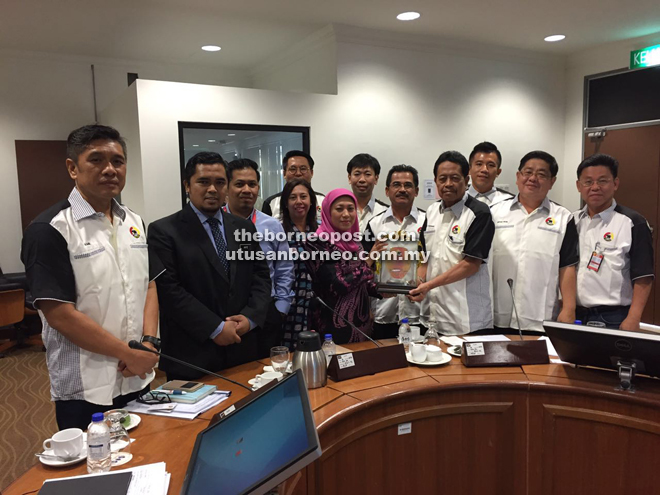 Nancy receives a memento from Sazali during the courtesy call.