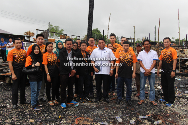 Romeo (front, fourth right) with the team from TM Sibu at the site where Rumah Jalak once stood.