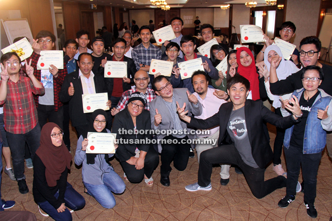 Participants gleefully striking a pose in a photo-op with workshop speakers and Azam personnel. Also seen is Mohamad Ariff (front, fourth left). — Photo by Chimon Upon