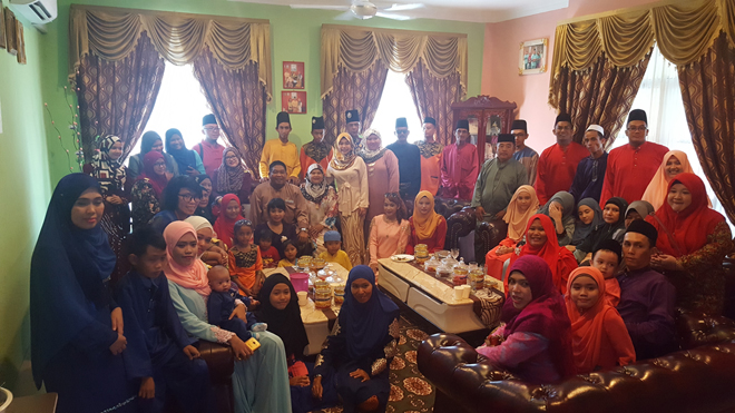 Paruwadi and wife Datin Siti Kadijah Abdullah with guests during the Raya open house on Wednesday.